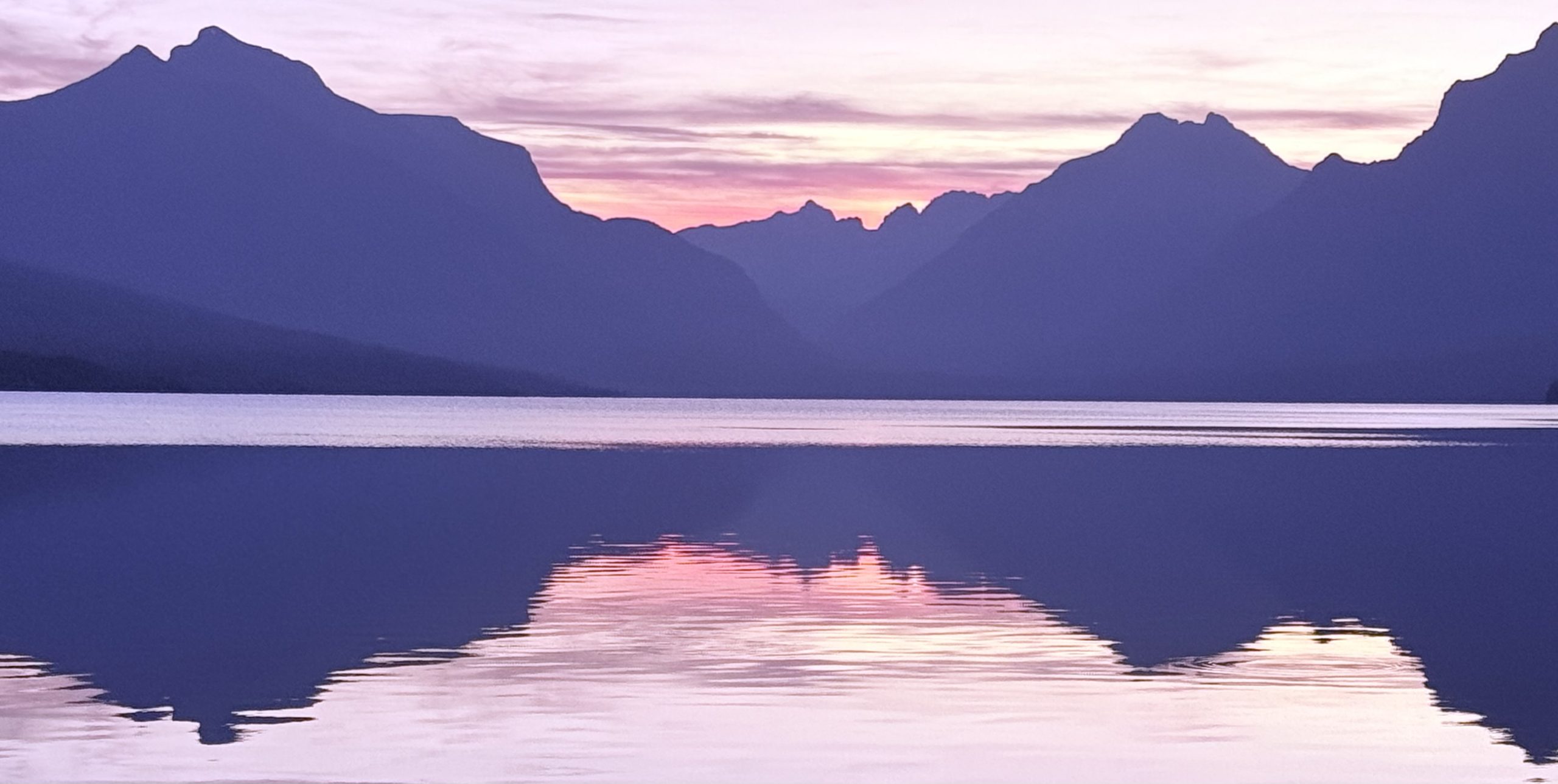 Mountains reflected in Lake McDonald at sunset