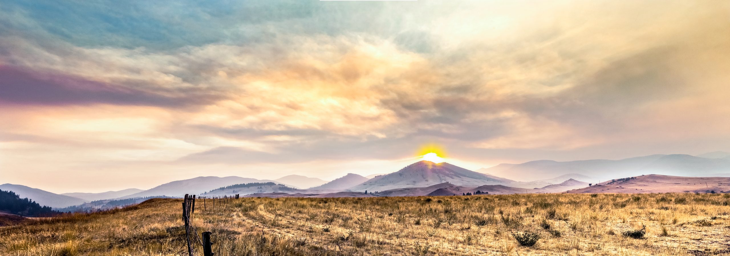Sun rising over the hills of a Montana grassland